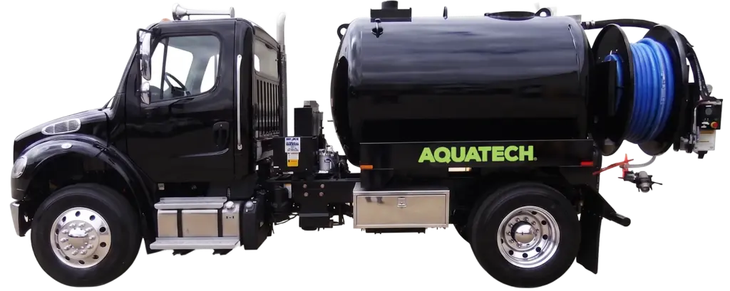 Aquatech combination sewer jetter truck with black tank and blue hose spool, designed for sewer cleaning operations.